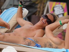 NastyAdult.info presents: Tattooed girl and her topless friend tanning topless